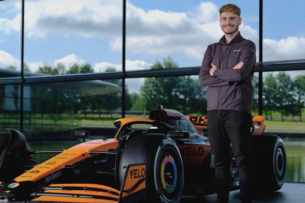 Profile photo of Charlie Russell in front of a McLaren F1 car