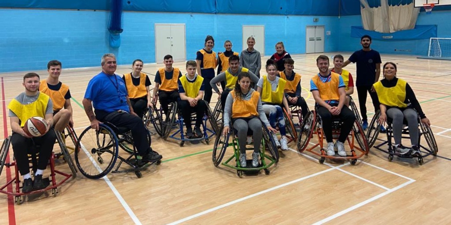Group of students playing wheelchair basketball