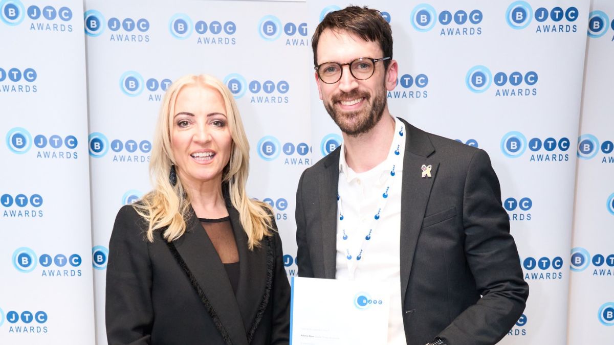 A picture of Journalism student Adonis Storr receiving his award