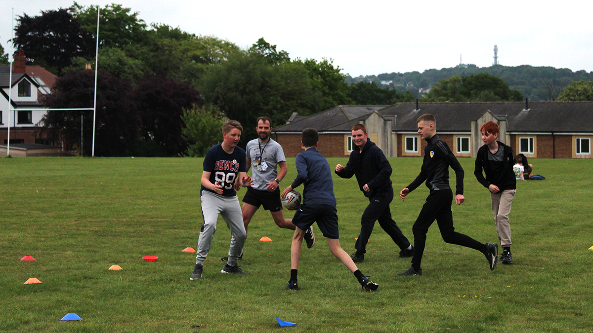 A group of school children playing football.
