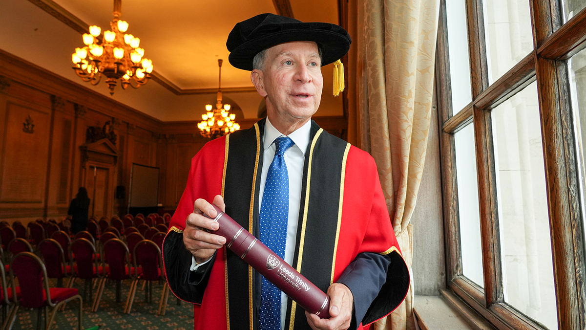 The Chancellor of Leeds Trinity University in official gown, holding his installation scroll.
