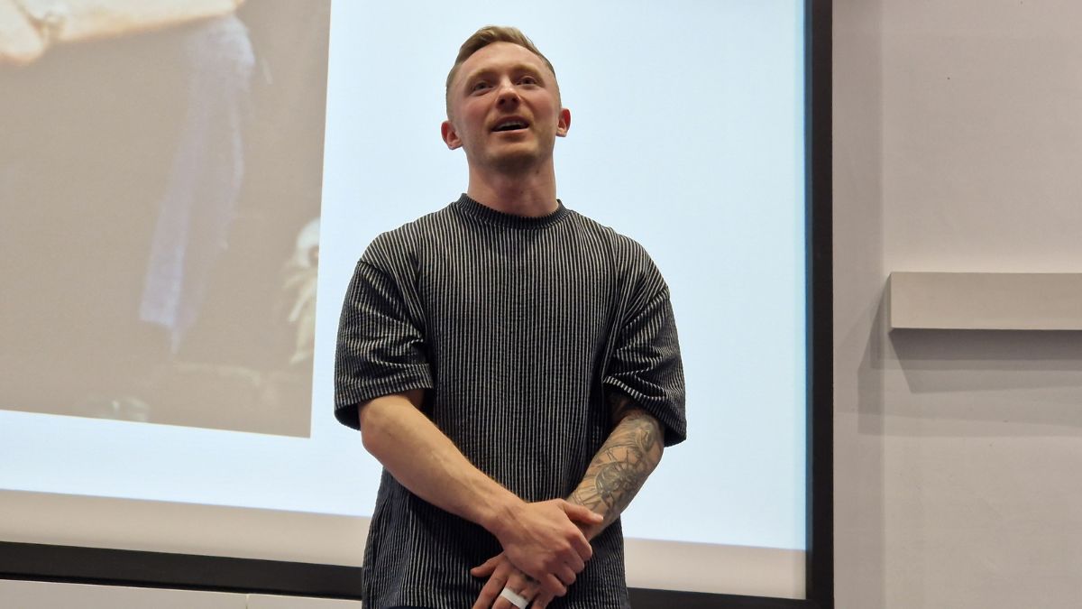 Olympian Nile Wilson stands at the front of an auditorium